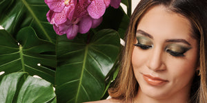 summer makeup trends woman in front of tropical bush