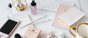 Several Makeup Products Sitting On A Desk