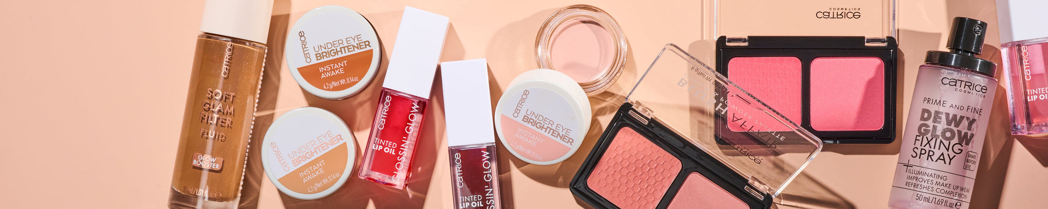 Image showing a group of our best selling makeup products like under eye brightener, soft glam filter fluid, gloss and glow lipgloss, cream and powder blushes and fixing spray to keep it all in place.