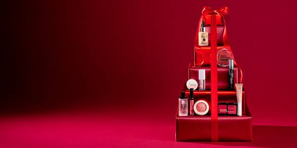30% off sale code glam30 Red gift tower with skincare products on a red background